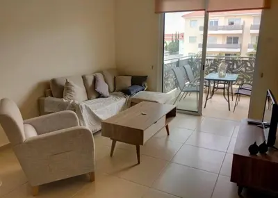 a living room with a couch and a table at Mythical Sands Luxury Apartment in Paralimni