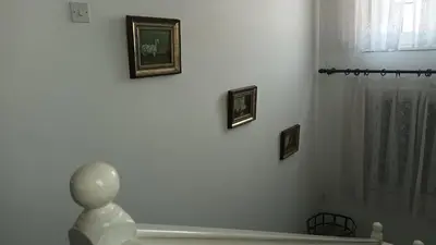 a bathroom with a shower and three pictures on the wall at Greenfields Country Club in Limassol