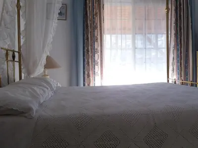 a bedroom with a white bed with a window at Greenfields Country Club in Limassol