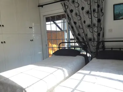 two beds in a room with a window at Greenfields Country Club in Limassol
