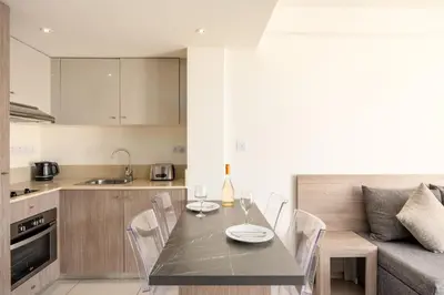 a kitchen and dining room with a table and chairs at Melpo Antia Hotel & Suites in Ayia Napa