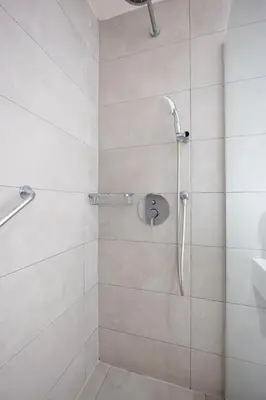 a shower with a glass door in a bathroom at Melpo Antia Hotel & Suites in Ayia Napa
