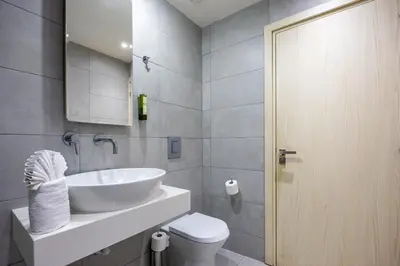 a bathroom with a sink and a toilet at Melpo Antia Hotel & Suites in Ayia Napa
