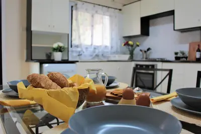 a table with a bowl of donuts on it in a kitchen at Salt Lake Town House in Larnaka