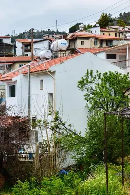 a white building with satellites on top of it at Aprosmeno Jacuzzi House 1 in Agros