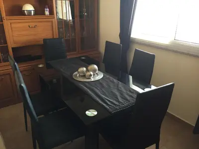 a dining room table with black chairs and a black table and chairsktop at 2 Bed Flat - Sleeps 4 - Pool - Parking - Wifi in Xylophaghou
