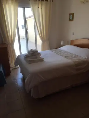 a bedroom with a bed with towels on it at 2 Bed Flat - Sleeps 4 - Pool - Parking - Wifi in Xylophaghou