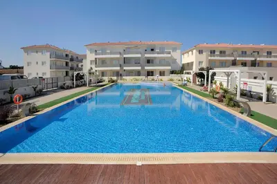 a large swimming pool in front of two apartment buildings at Mythical Sands new Luxury Apartment in Paralimni