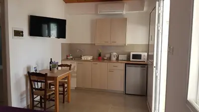 a kitchen with a table and a small kitchen with a table and chairs at ZORBAS Sea View No 1 - Antoniella in Larnaka