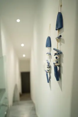 a hallway with shoes hanging on a wall at Andreotis Villas in Protaras