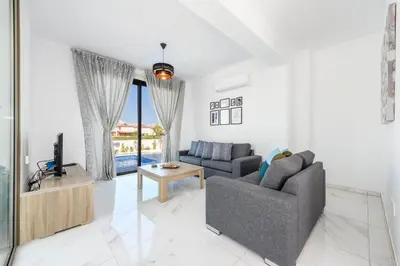 a living room with a couch and a tv at Levanda #40 in Protaras