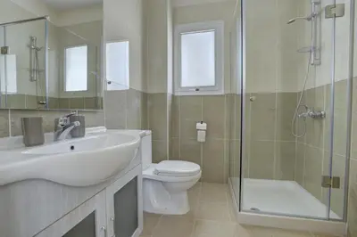 a bathroom with a sink and a toilet and a shower at Villa Nissi Gold in Ayia Napa