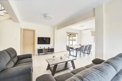 a living room with a couch and a table at Villa Nissi Gold in Ayia Napa