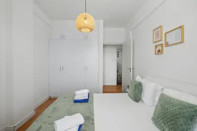 a bedroom with a white bed and a pendant light at Lazuli Sea View Beachfront- Ap 61 in Larnaka