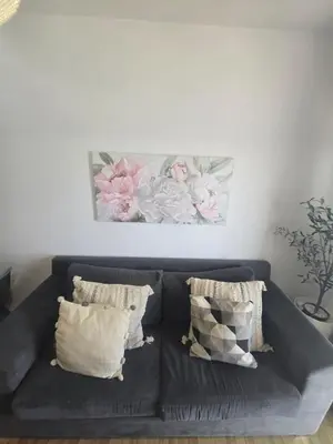 a black couch with pillows in a living room at Lazuli Sea View Beachfront- Ap 61 in Larnaka