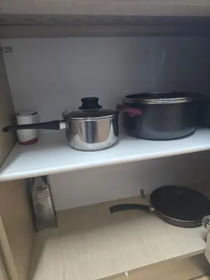 two pots and pans on a shelf in a kitchen at Lazuli Sea View Beachfront- Ap 61 in Larnaka