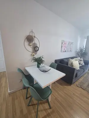 a living room with a table and chairs and a couch at Lazuli Sea View Beachfront- Ap 61 in Larnaka