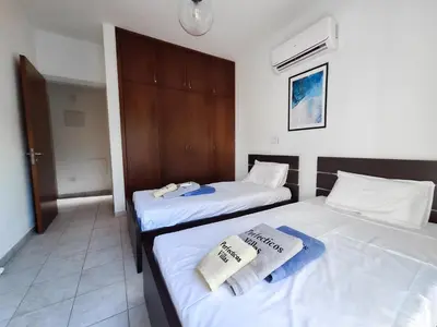 two beds in a hotel room with towels on them at Villa Lynn Chill Out Seaview in Ayia Napa