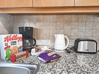 a kitchen counter with a sink and a coffee maker at Villa Lynn Chill Out Seaview in Ayia Napa