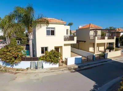 a large white house with a palm tree at Villa Lynn Chill Out Seaview in Ayia Napa
