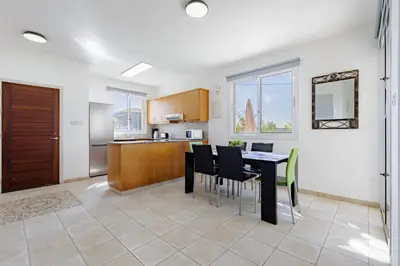 a kitchen and dining room with a table and chairs at Villa Lynn Chill Out Seaview in Ayia Napa