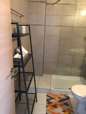 a bathroom with a shower and a toilet at Must Stay - City Center in Larnaka
