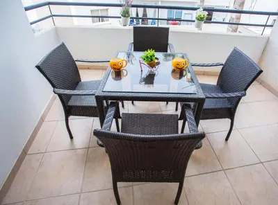 a table and chairs with pumpkins on it on a balcony at Yippee! Apartments I Town Center in Larnaka