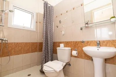 a bathroom with a toilet and a sink and a shower at Konnos Villa Ekaterina in Protaras