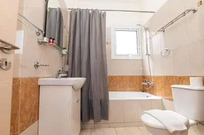 a bathroom with a toilet and a sink and a shower at Konnos Villa Ekaterina in Protaras