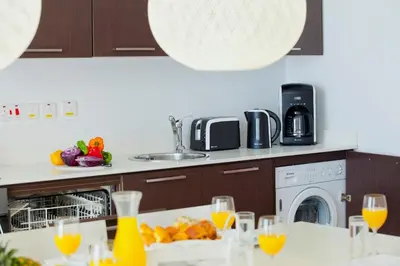 a kitchen with a table with glasses of orange juice at Althea Kalamies Luxury Villas in Protaras