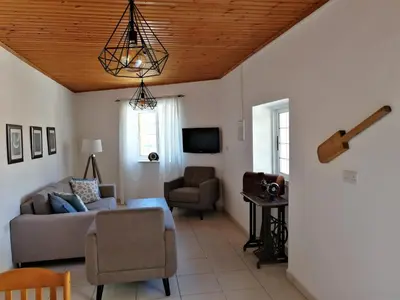 a living room with a couch and a chair at Lemon Tree Courtyard in Larnaka