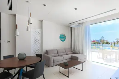 a living room with a couch and a table at NAPA GEM SUITES by LUXEL VILLAS in Ayia Napa