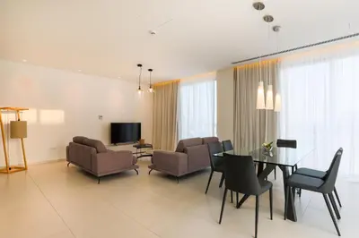 a living room with a dining table and chairs at NAPA GEM SUITES by LUXEL VILLAS in Ayia Napa