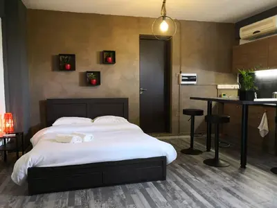 a bedroom with a large bed and a table at The room in Larnaka