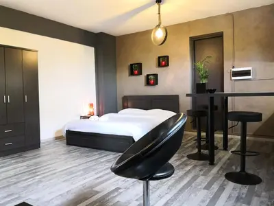 a bedroom with a bed and a table and stool at The room in Larnaka