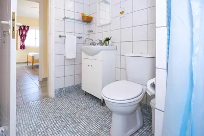 a white bathroom with a toilet and a sink at Villa Aleta in Protaras