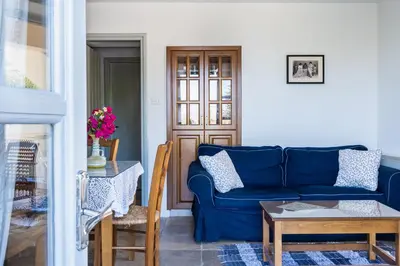 a living room with a blue couch and a table at Aunt Maria's in Pano Lefkara