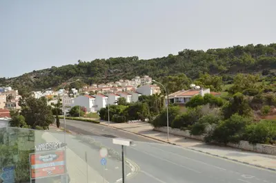 a view of a street with houses on a hill at Proteas Mare Suites in Protaras