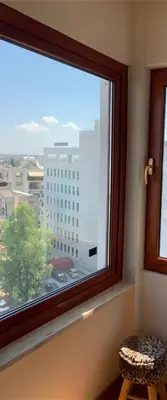 a window with a view of a tall building at Modern 2 bed room large apartment in Nicosia