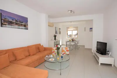 a living room with a couch and a table at Villa Pomelo in Protaras