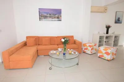 a living room with a couch and a glass table at Villa Pomelo in Protaras