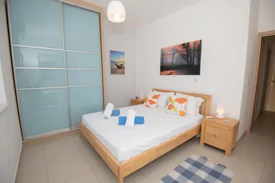 a bedroom with a bed and a glass wall at Villa Pomelo in Protaras