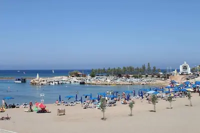 a beach with a bunch of people on the beach at Villa Pomelo in Protaras