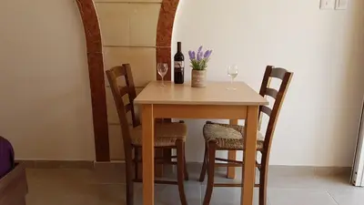 a table with two wine glasses and a bottle of wine at ZORBAS No 3 in Larnaka