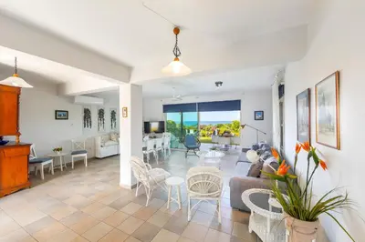 a living room with a couch and a table at Protaras Sirina Waterfront Villa in Protaras