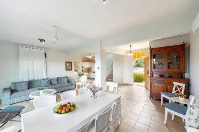 a living room with a couch and a table at Protaras Sirina Waterfront Villa in Protaras