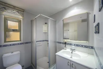 a bathroom with a toilet and a sink and a shower at Protaras Sirina Waterfront Villa in Protaras