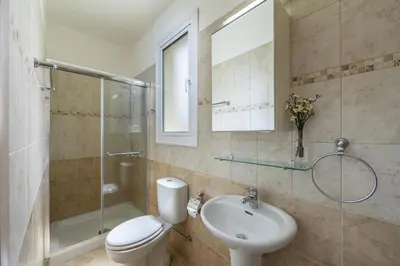 a bathroom with a toilet and a sink and a shower at Kalimera Villa Protaras in Protaras