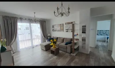 a living room with a couch and a table at Aquamarine in Voroklini