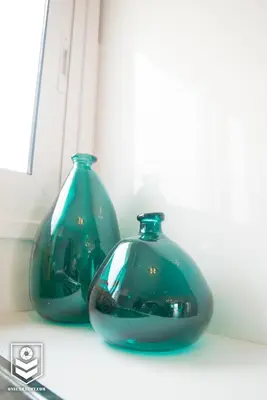 two blue glass vases sitting on a window sill at Aquamarine in Voroklini
